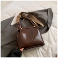Dark brown oil wax leather bucket bag with decorative gold rivets and woven wide strap - Coffee