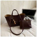 Deep brown tote bag set with matching pouch and bead charm in a lifestyle office setting - Reddish Brown With Pendant