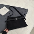 Macro detail of black frosted suede tote bag with leather strap and square metal buckle - Black