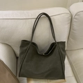 Minimalist large dark grey tote bag with thin shoulder straps on a cozy sofa - Green