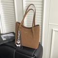 Detail of brown matte tote bag with adjustable gold buckles and Schnauzer dog charm - Brown with Pendant
