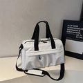 Detail of waterproof travel bag featuring dual zippers and adjustable black shoulder strap - Off White