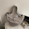 Detail of grey nylon crescent bag showing textured fabric and multiple zipper pulls - Small / Gray