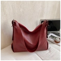 Detail of burgundy large hobo bag with wide shoulder strap and metal zipper on white fabric - Burgundy
