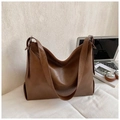 Detail of brown faux leather tote bag with lychee texture and laptop for office commuting - Brown