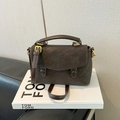 Detail of vintage dark brown crossbody bag with gold hardware on minimalist background - Brown