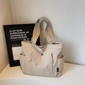Bolso tote beige grande de diseño minimalista con bolsillos y correa ancha al hombro - Blanco Roto