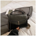 Fashionable black oil-wax leather handbag with silver twist lock and woven strap - Black
