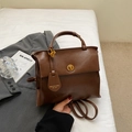 Vintage dark brown faux leather backpack with retro metal buckle and side brand tag - Brown