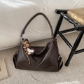 Detail of vintage coffee brown tote bag with leather texture and heart shaped charm accessory - Coffee with Pendant