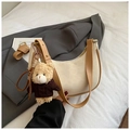 Detail of crescent shoulder bag in off-white leather with cute brown teddy bear pendant - With Charm / Off White