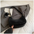 Detail shot of black leopard-print hobo bag with gold zipper on grey suit and white bedding - No Pendant / Black