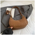 Detail shot of a brown leopard print crescent hobo bag with adjustable strap on fabric - No Pendant / Brown