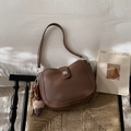 Detail of dark brown lychee texture leather saddle bag with plush ice cream charm - Coffee (With Pendant)