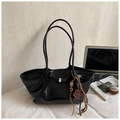 Black glossy tote bag with leopard bear charm and minimalist silver buckle detail - Black