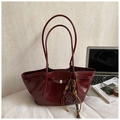 Deep burgundy large tote bag with silver buckle and leopard bear charm on desk - Burgundy