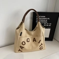 Minimalist beige canvas tote bag with brown leather handles and brand logo lettering - Khaki