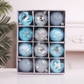 Detail view of 12 light blue Christmas ornaments with varied textures in a gift box - Blue