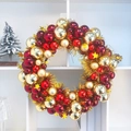 Close-up of a festive Christmas wreath with red and gold baubles and stars on a white shelf - 45cm / Wine Red + Gold Regular Style