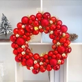 Detailed view of festive Christmas wreath featuring shiny red and gold baubles and glitter tinsel - 45cm / Red + Gold Regular Style