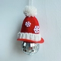 Festive disco ball ornament with a red snowflake knit hat and a white hanging string - Snowflake Hat Mirror Ball Pendant