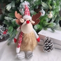 Detail of Christmas reindeer plush with red knit hat and scarf in a festive holiday scene - Christmas Reindeer Doll