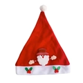Dettaglio del cappello di Natale rosso in peluche con patch Babbo Natale 3D e agrifoglio - Stile Bambino Babbo Natale
