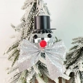 Macro detail of disco ball snowman ornament with silver bow on a Christmas tree branch - Snowman Silver Bow 4cm Ball