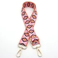 Detail of adjustable woven bag strap with pink geometric diamond patterns and gold hooks - No. 4 Pink Orange Coffee