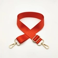 Close-up of orange nylon adjustable shoulder strap with gold metal spring hooks - Orange