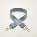 Close-up of light blue adjustable nylon bag strap with polished gold metal hardware - Light Blue