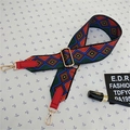 Detail view of colorful geometric woven bag strap with red leather ends and gold metal hooks - Style 3 Red