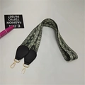 Detail view of snakeskin print bag strap with golden metal carabiners and leather ends - Snake Print