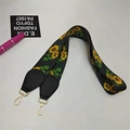 Detail of sunflower pattern webbing strap with black leather ends and gold lobster clasps - Silver Clasp / Sunflower
