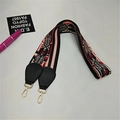 Close-up of ethnic style woven bag strap with red heart pattern and golden hooks - Glamorous Colors