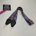Close-up of paisley pattern on ethnic style wide bag strap with gold metal hooks - Morning Glory