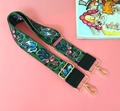 Detail of adjustable green strap with colorful butterfly embroidery and gold metal hooks - Butterfly