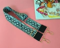 Close-up of adjustable snakeskin pattern bag strap with gold metal hardware and black leather - Snake Print