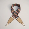 Close-up of colorful striped wide woven shoulder strap with gold metal hooks and leather detail - Khaki