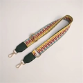 Detail of colorful geometric woven bag strap with golden metal swivel hooks and leather ends - Light with Green