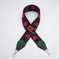 Detail view of the embroidered red heart pattern on the black wide woven bag strap - Green