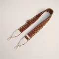 Detail of red and brown geometric woven bag strap with gold hardware and white leather - Dark with White