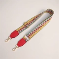 Close-up of colorful ethnic woven strap with red leather ends and gold metal hooks - Light with Red