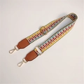 Detail of colorful woven geometric bag strap with brown leather and gold metal clips - Light with Brown