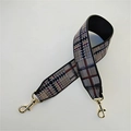 Close-up of wide geometric jacquard strap with gold metal swivel lobster clasps - Plaid Brown