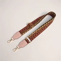 Close-up of adjustable woven shoulder strap with gold hardware and ethnic pattern - Dark with Light Pink