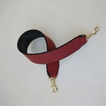 Close-up of wide PU leather handbag strap in wine red with gold metal lobster clasps - Burgundy