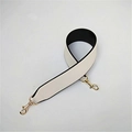 Detail of cream PU leather bag strap with black edges and gold metal swivel clasps - White