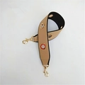 Macro shot of khaki and black wide PU shoulder strap with gold metal eyelet details - Khaki