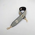 Close-up of wide grey PU shoulder strap with gold metal eyelets and swivel lobster clasps - Gray